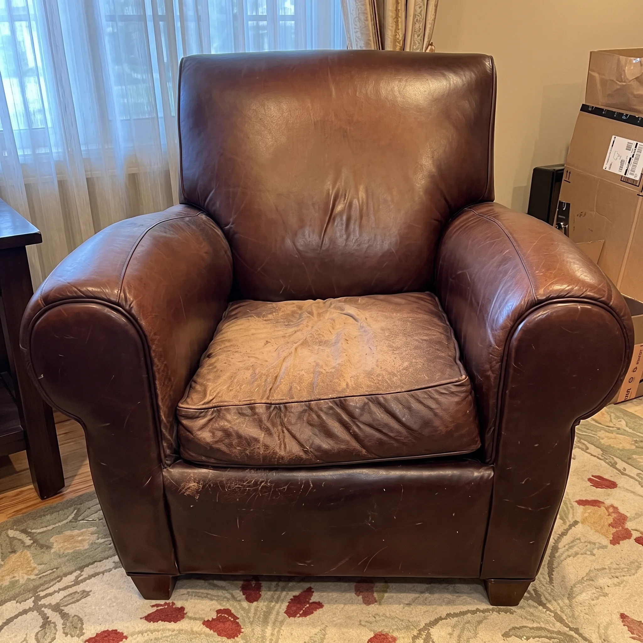 Mottled, worn brown leather sofa before restoration